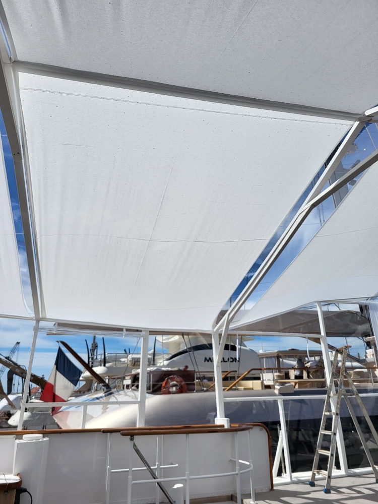 Investor hospitality Cannes: a yacht deck fitted as a reception space under a crystal awning during a congress